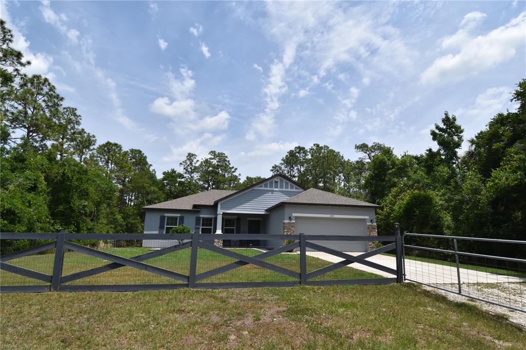 14241 Ravine Avenue Weeki Wachee, FL 34614 - Photo 40 of 48 a view of house with a yard and entertaining space