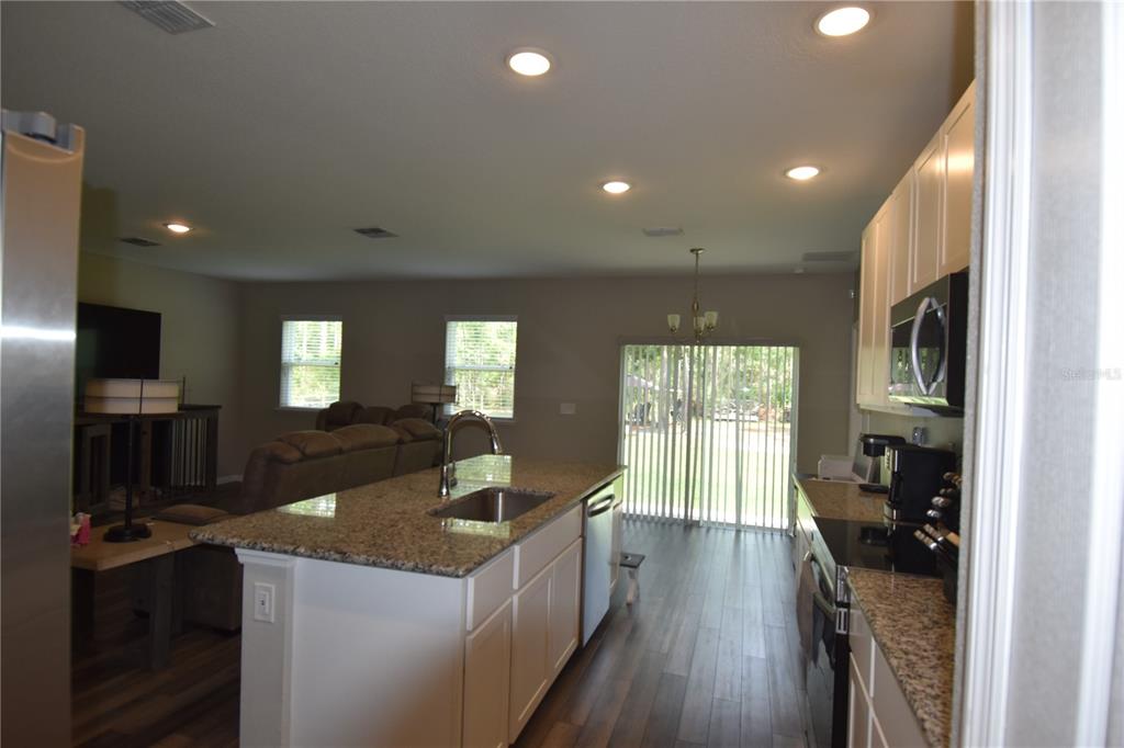 14241 Ravine Avenue Weeki Wachee, FL 34614 - Photo 6 of 48 a kitchen with sink stove and refrigerator