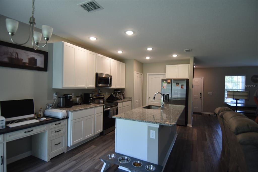 14241 Ravine Avenue Weeki Wachee, FL 34614 - Photo 7 of 48 a kitchen with cabinets a sink and appliances