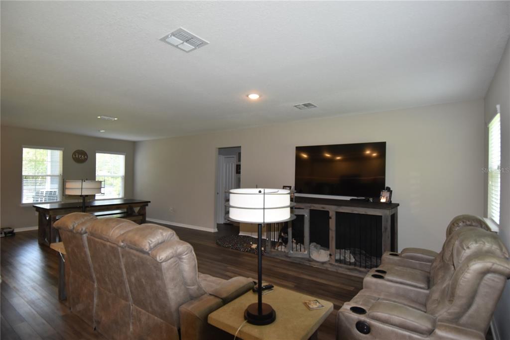14241 Ravine Avenue Weeki Wachee, FL 34614 - Photo 8 of 48 a living room with furniture and a flat screen tv