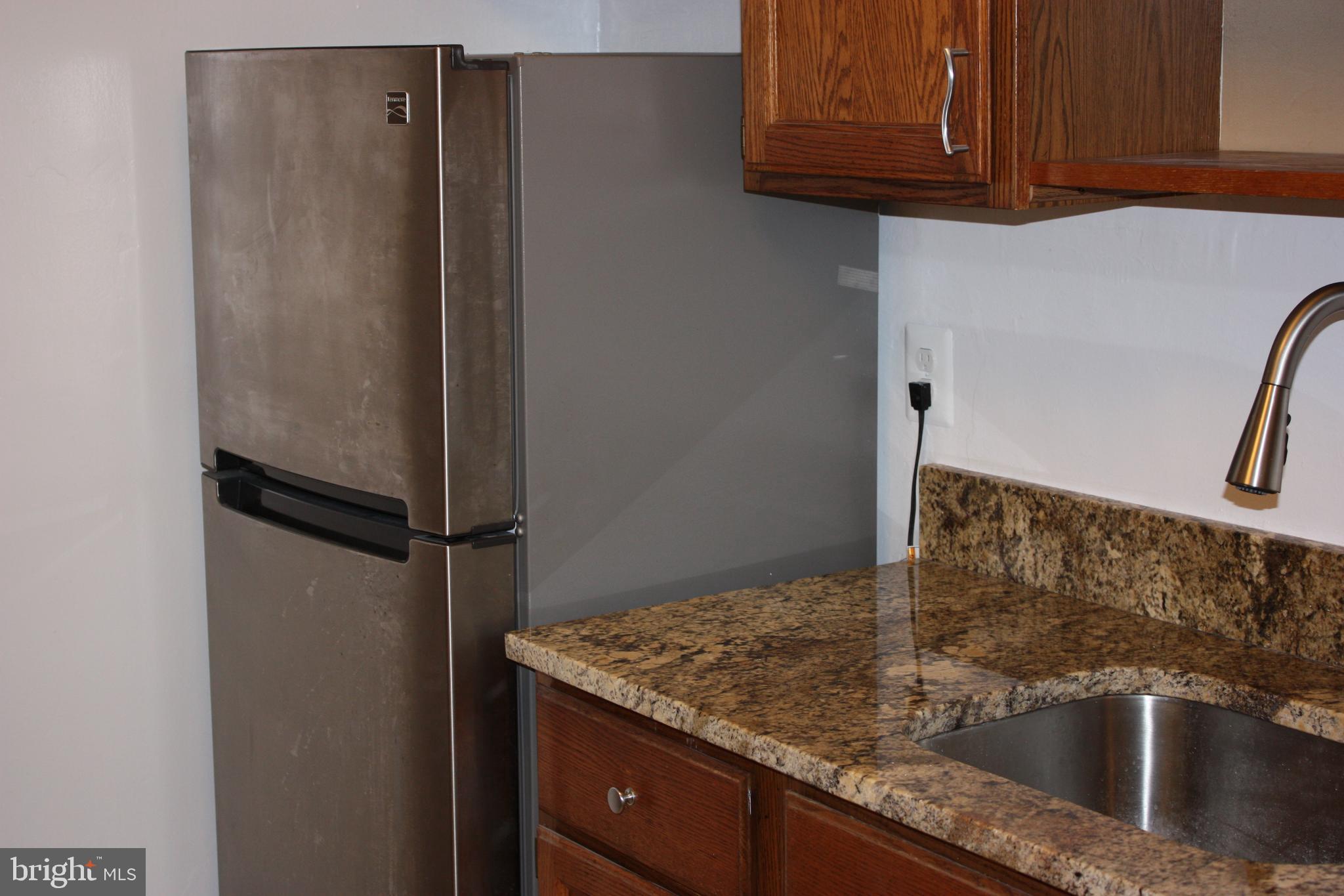 a close view of a sink and refrigerator