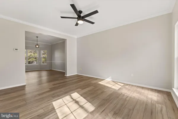 a view of a room with wooden floor and windows