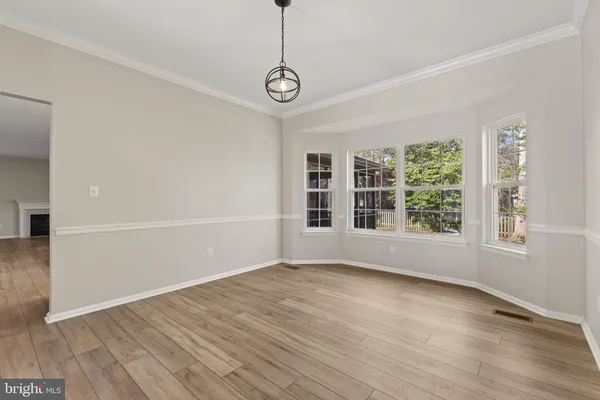 a view of kitchen with furniture and wooden floor