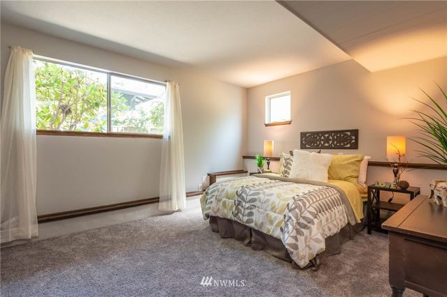 a bedroom with a bed and window
