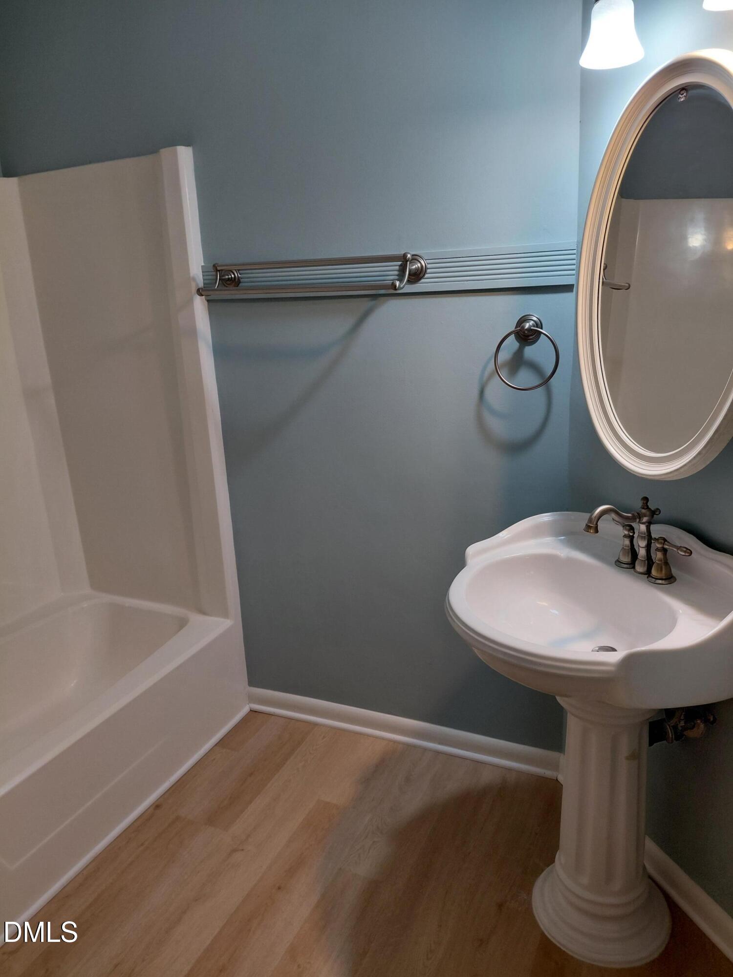 804 Olive Street Apex, NC 27502 - Photo 34 of 60 a bathroom with a sink and a mirror