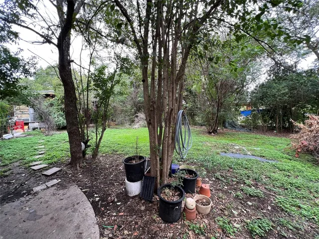 a view of a backyard with garden and entertaining space
