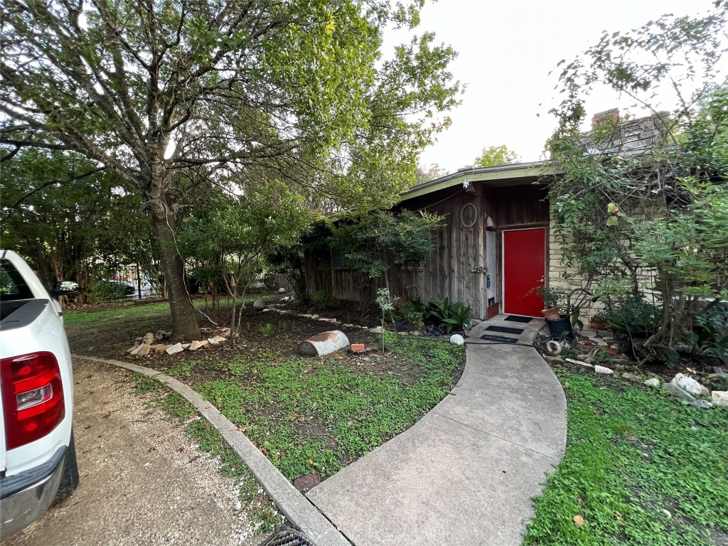905 Neans Drive Austin, TX 78758 - Photo 9 of 40 a view of a patio with table and chairs a barbeque and a large tree