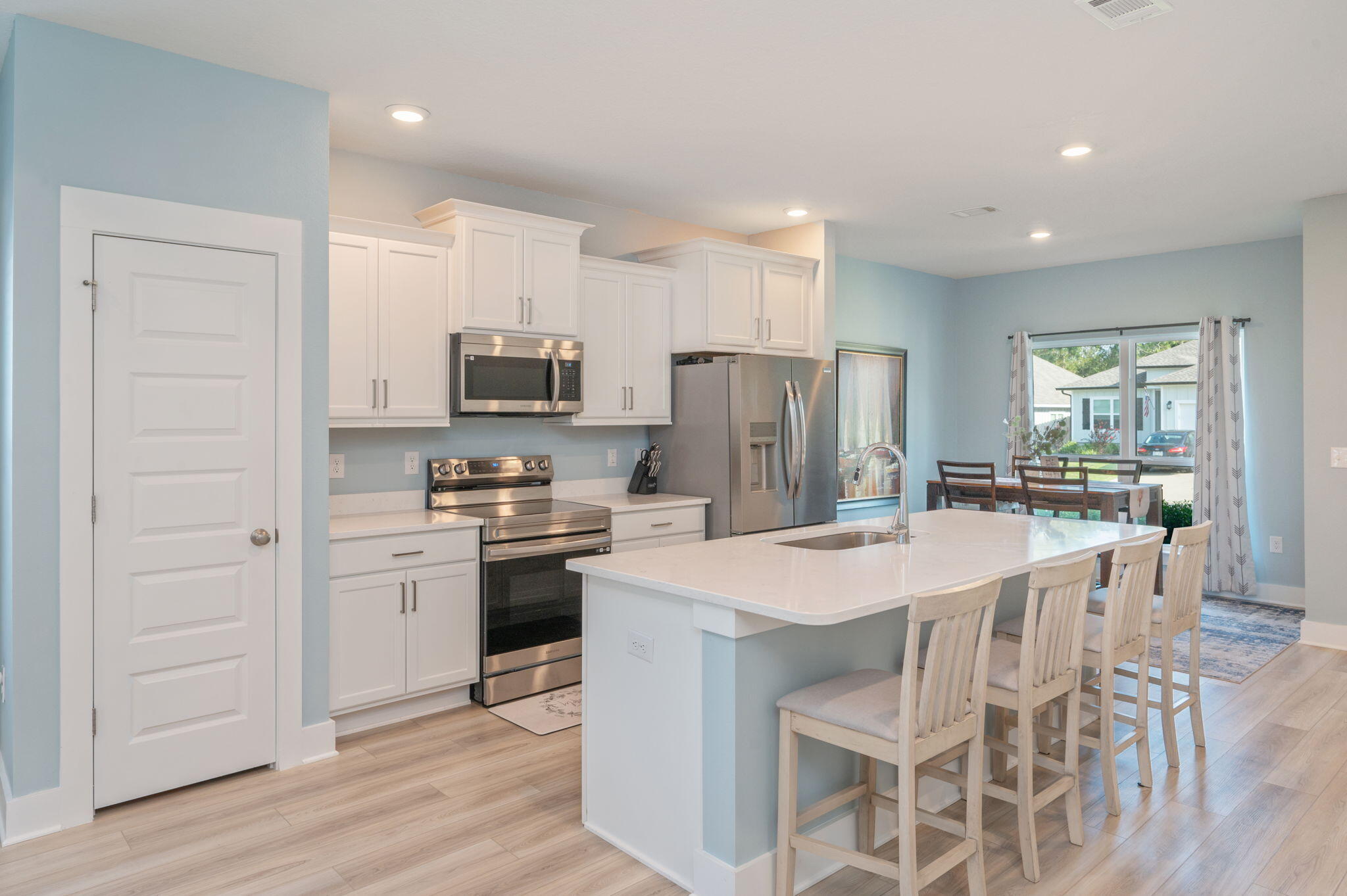 109 Blooming Cove Crestview, FL 32539 - Photo 11 of 42 a kitchen with kitchen island a refrigerator stove microwave and cabinets