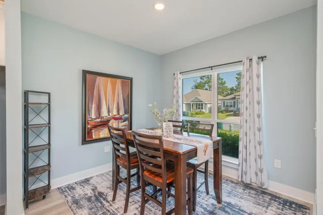 a view of a dining room with furniture window and wooden floor