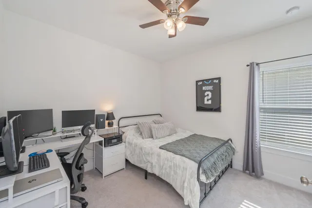 a bedroom with a bed and a desk