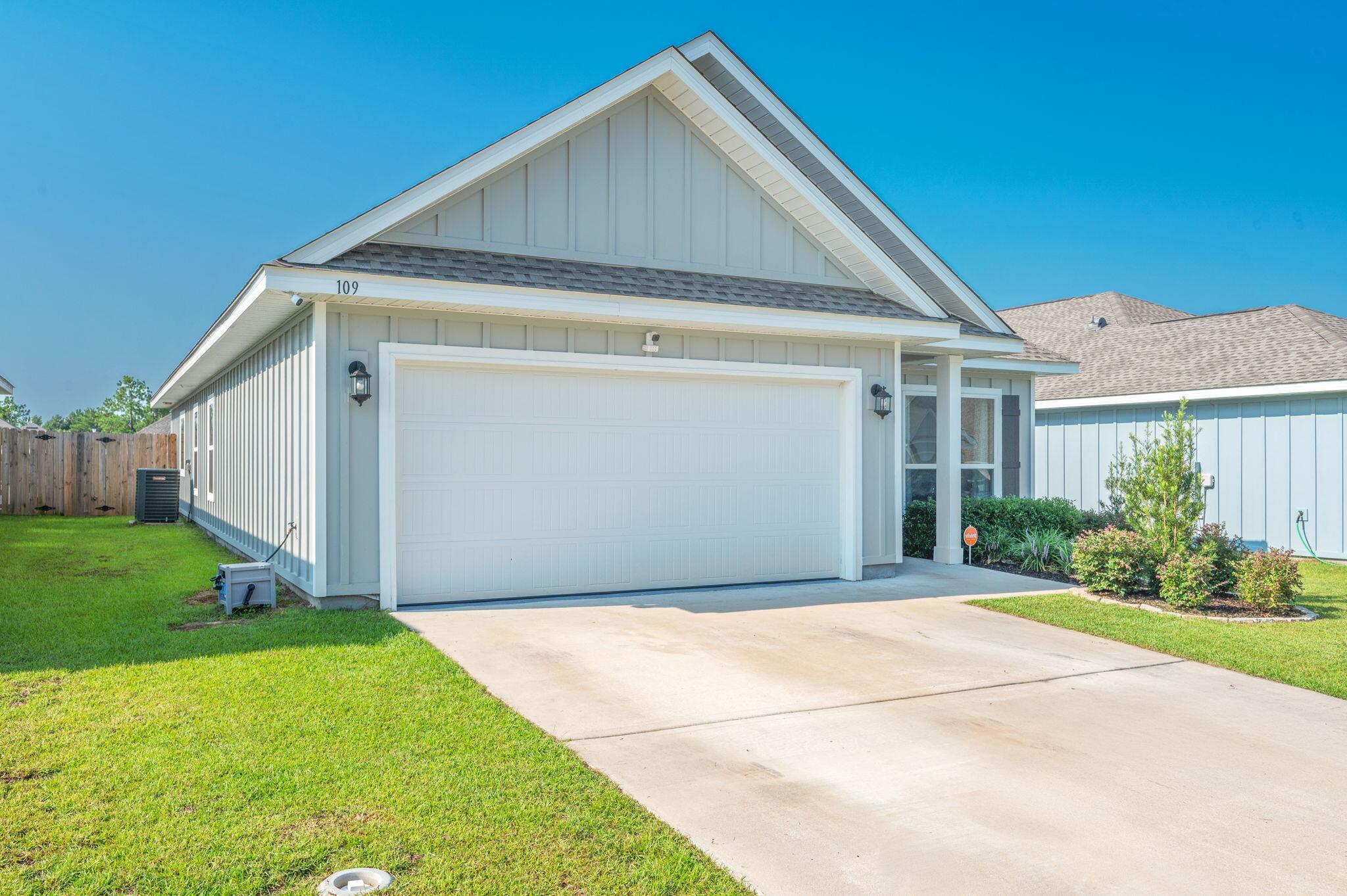 109 Blooming Cove Crestview, FL 32539 - Photo 4 of 42 a front view of a house with garden