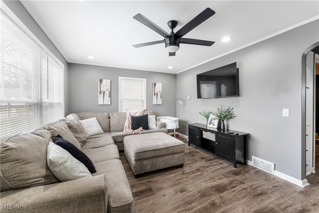 2908 19th Street Northwest Canton, OH 44708 - Photo 10 of 45 Living room featuring a ceiling fan, lvt flooring, and a healthy amount of sunlight