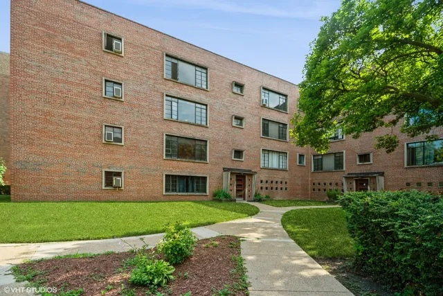 a front view of a building with a garden