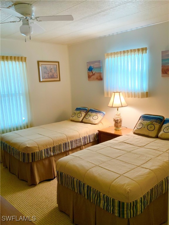 15550 Burnt Store Road, Unit 188 Punta Gorda, FL 33955 - Photo 23 of 37 a bedroom with two beds and a table