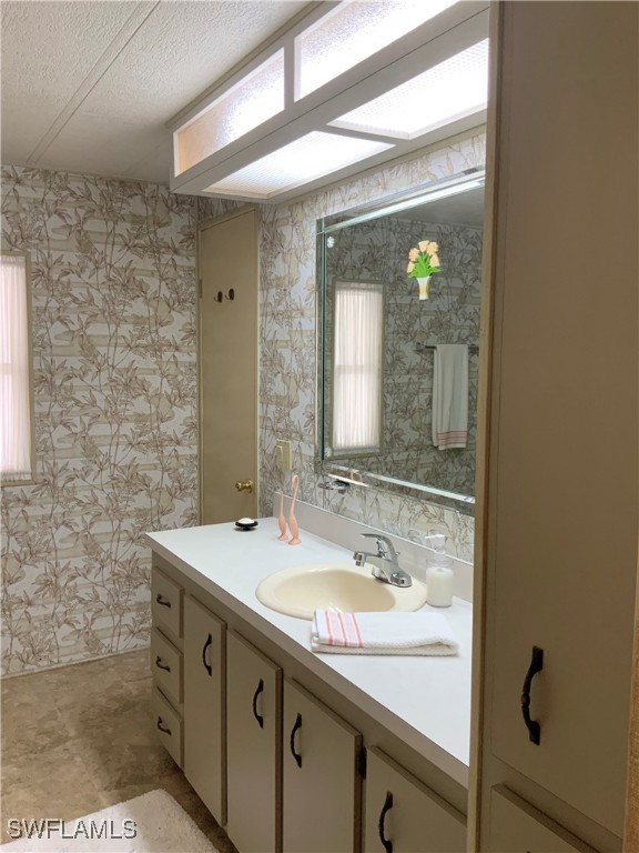 15550 Burnt Store Road, Unit 188 Punta Gorda, FL 33955 - Photo 25 of 37 a bathroom with a sink and a mirror