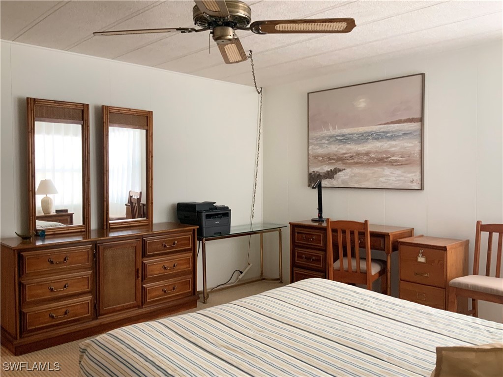 15550 Burnt Store Road, Unit 188 Punta Gorda, FL 33955 - Photo 27 of 37 a bedroom with a bed and a flat screen tv