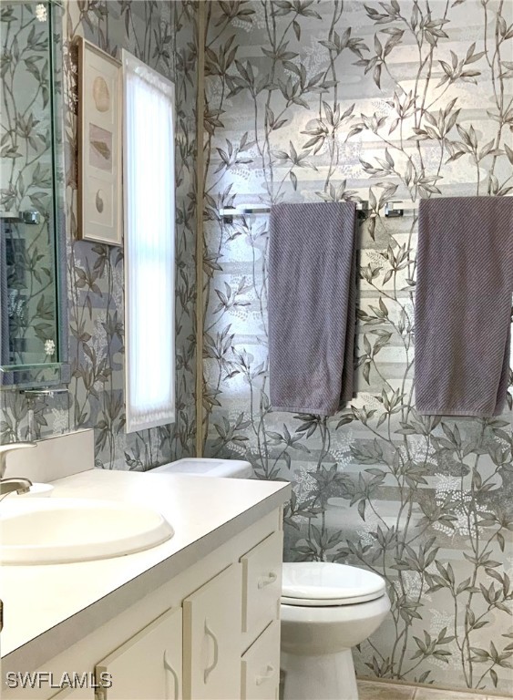 15550 Burnt Store Road, Unit 188 Punta Gorda, FL 33955 - Photo 28 of 37 a bathroom with a sink and mirror with toilet