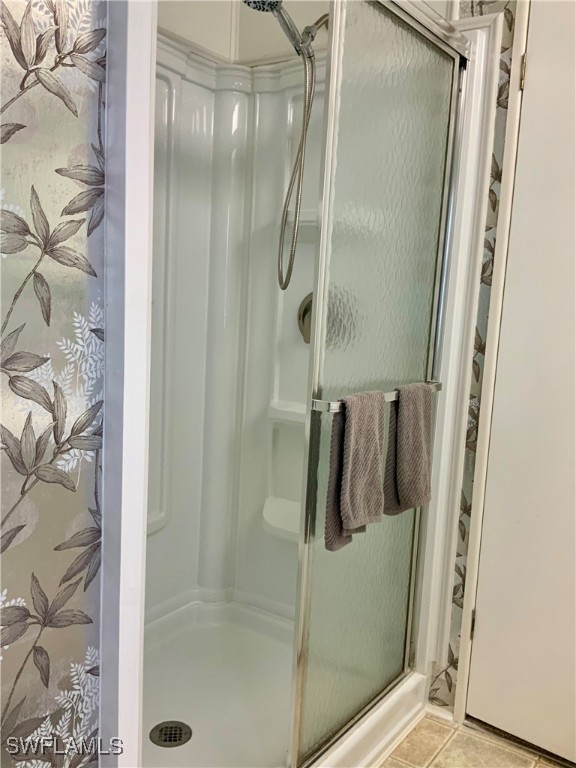 15550 Burnt Store Road, Unit 188 Punta Gorda, FL 33955 - Photo 30 of 37 a bathroom with a glass shower door