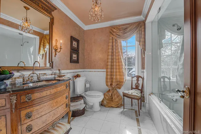 a bathroom with a granite countertop toilet a sink and a bathtub