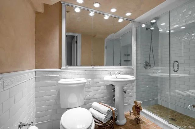 a bathroom with a sink toilet and shower