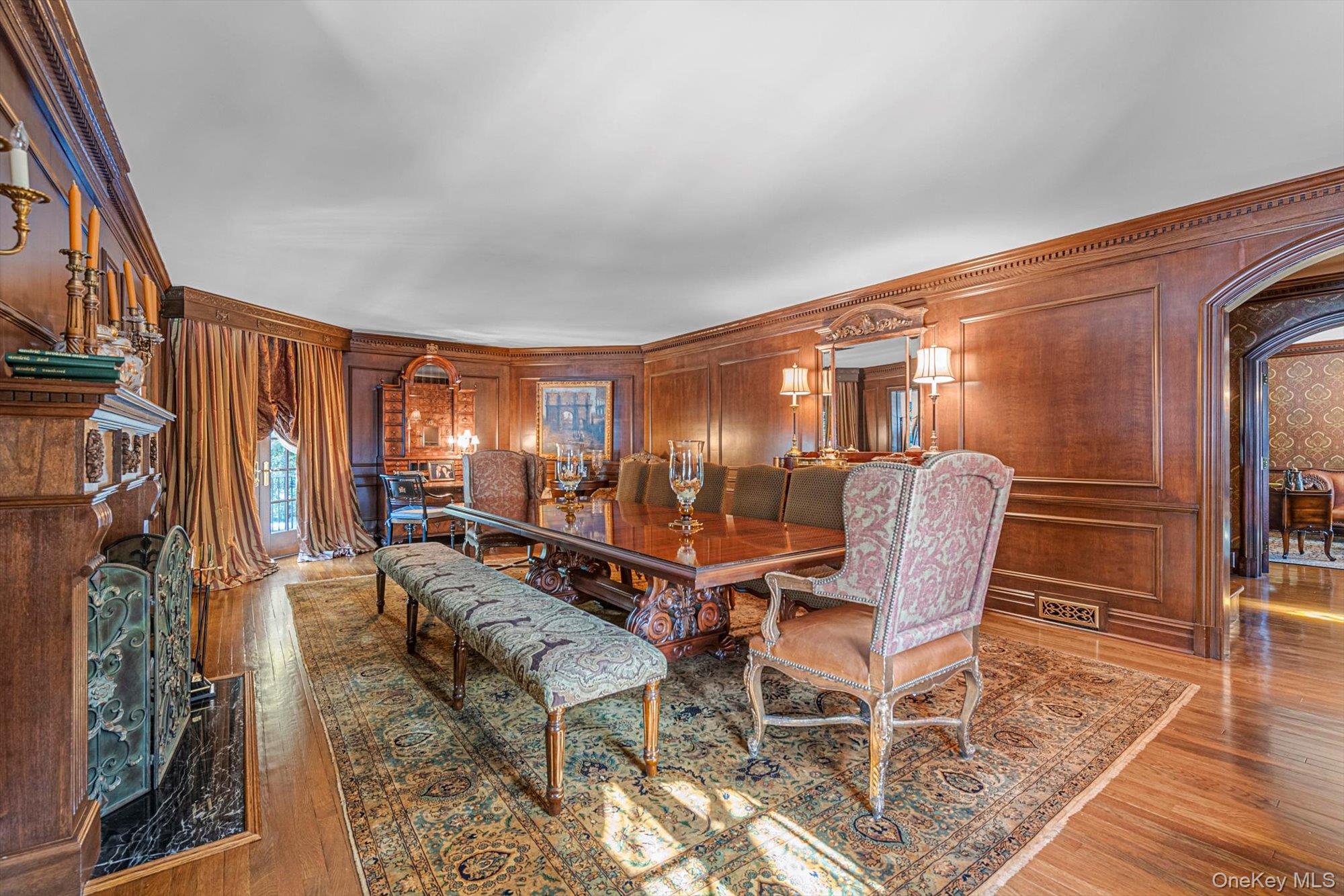 183 Mill Spring Road Manhasset, NY 11030 - Photo 10 of 32 Grand dining room, featuring fireplace & Juliet balcony creates atmosphere of timeless elegance