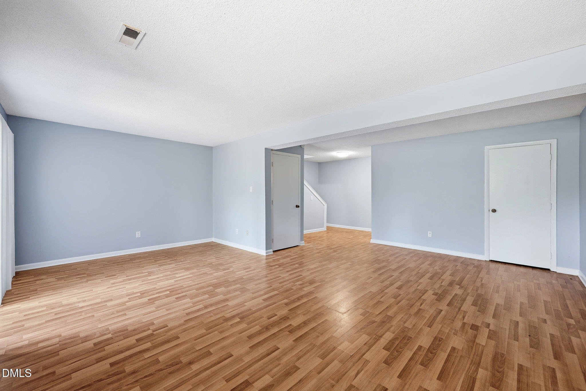 5043 Tall Pines Court Raleigh, NC 27609 - Photo 27 of 37 a view of empty room with wooden floor and fan