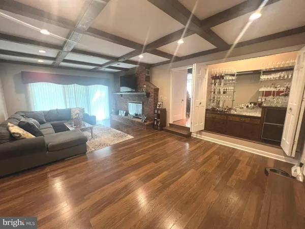 a living room with furniture a air conditioner vent and a window