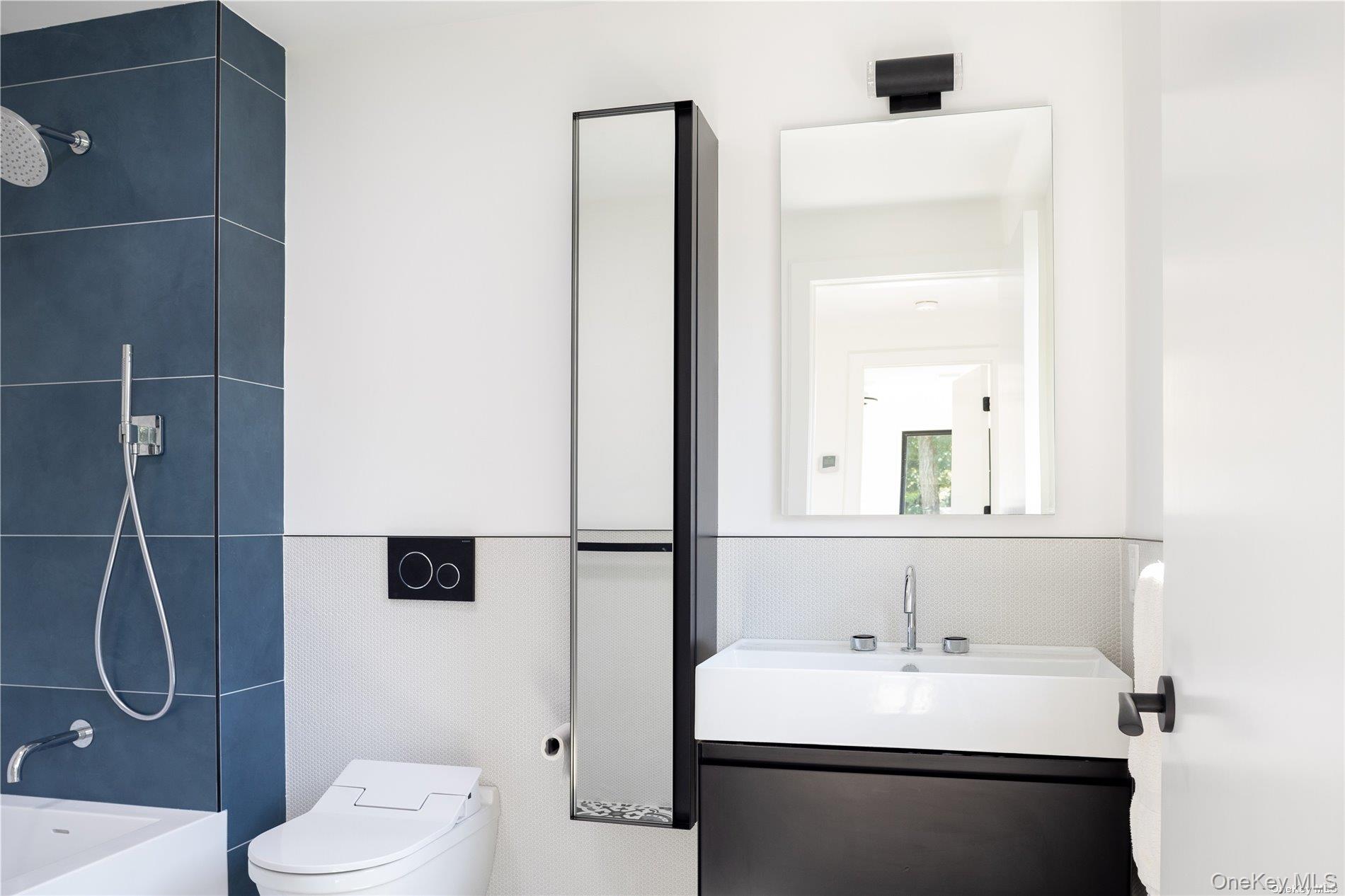 290 Windward Road Orient, NY 11957 - Photo 27 of 31 a bathroom with a sink toilet and mirror