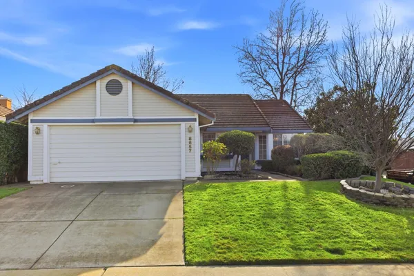 a front view of house with yard and green space