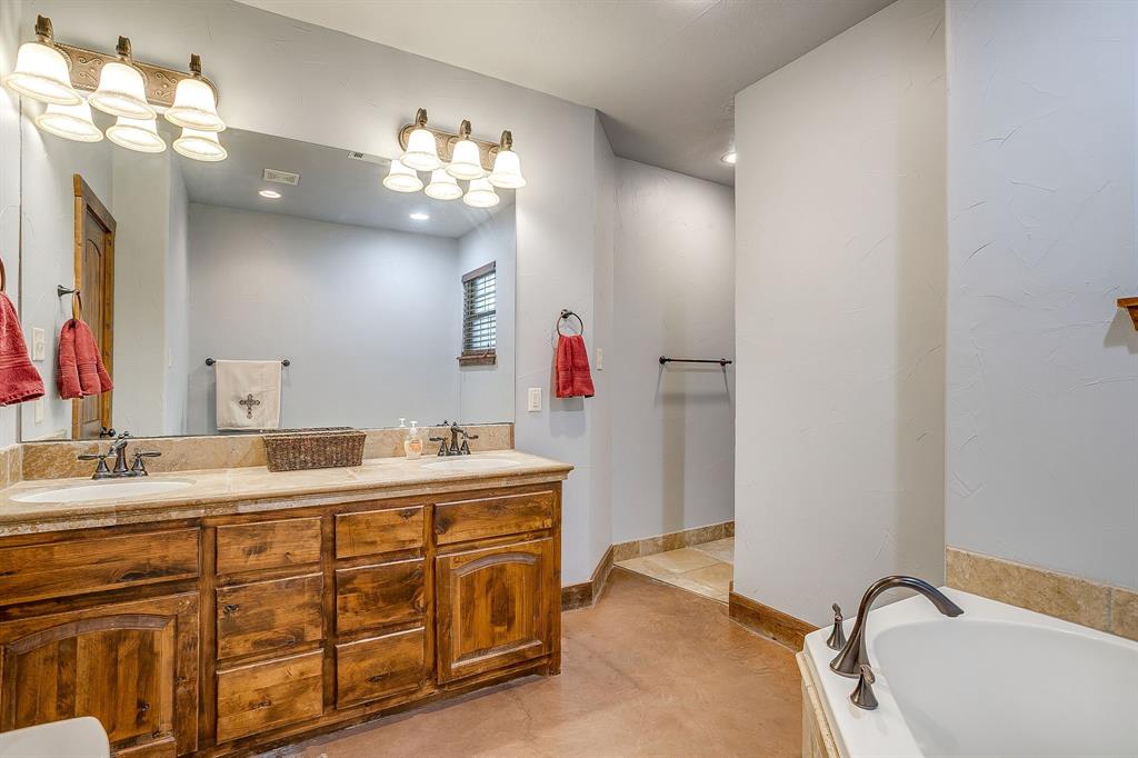 2220 Lazy Bend Road Millsap, TX 76066 - Photo 27 of 36 a bathroom with a sink vanity and a mirror