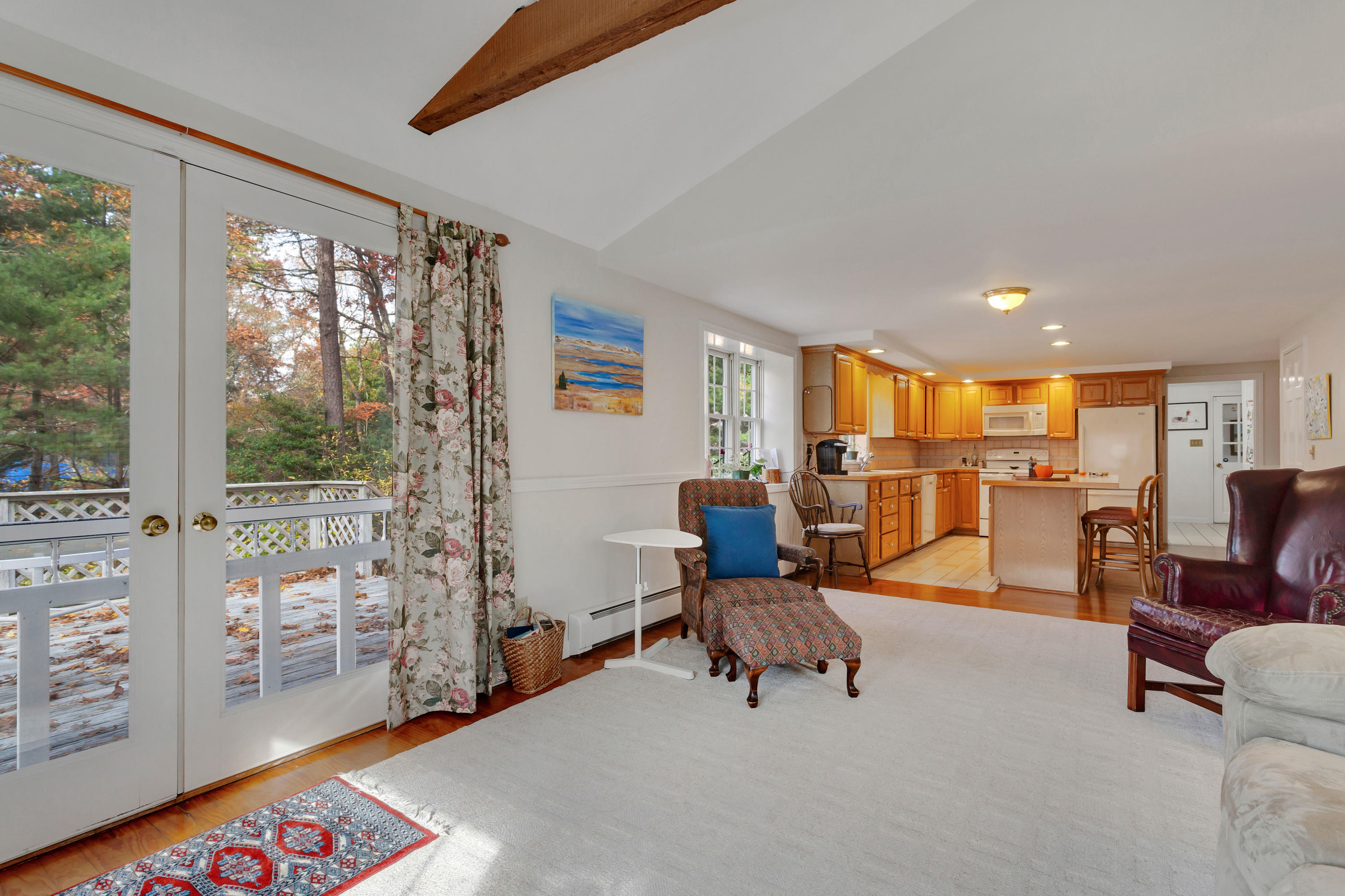 133 Ralyn Road Cotuit, MA 02635 - Photo 10 of 47 a living room with furniture and a floor to ceiling window