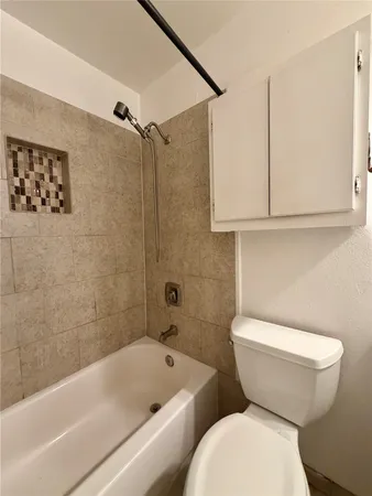 a bathroom with a toilet a sink and bathtub