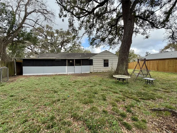 a view of a house with a backyard