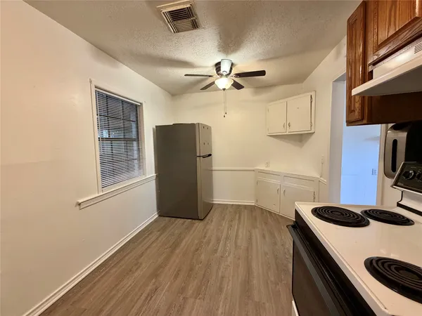 a kitchen with a refrigerator and a stove