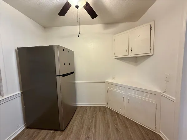 a kitchen with a refrigerator and cabinets