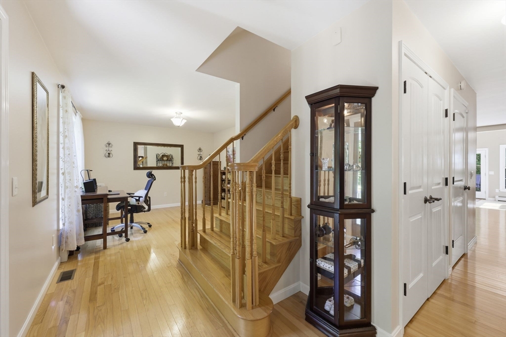 345 Bragg Road Warren, MA 01585 - Photo 6 of 41 a view of a hallway with wooden floor and staircase