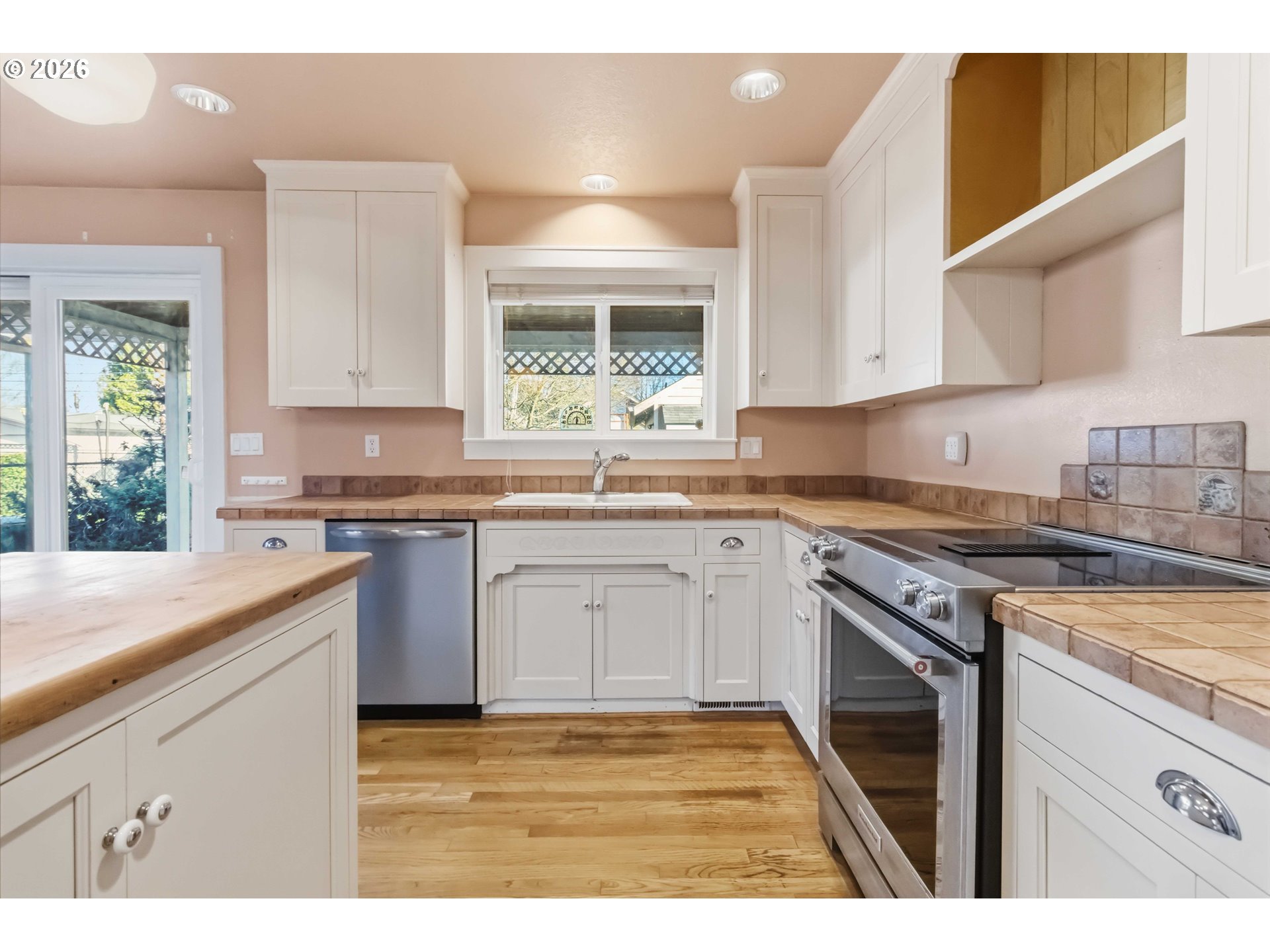 3008 Garfield Street Longview, WA 98632 - Photo 23 of 45 a kitchen with granite countertop a sink stainless steel appliances white cabinets and a window