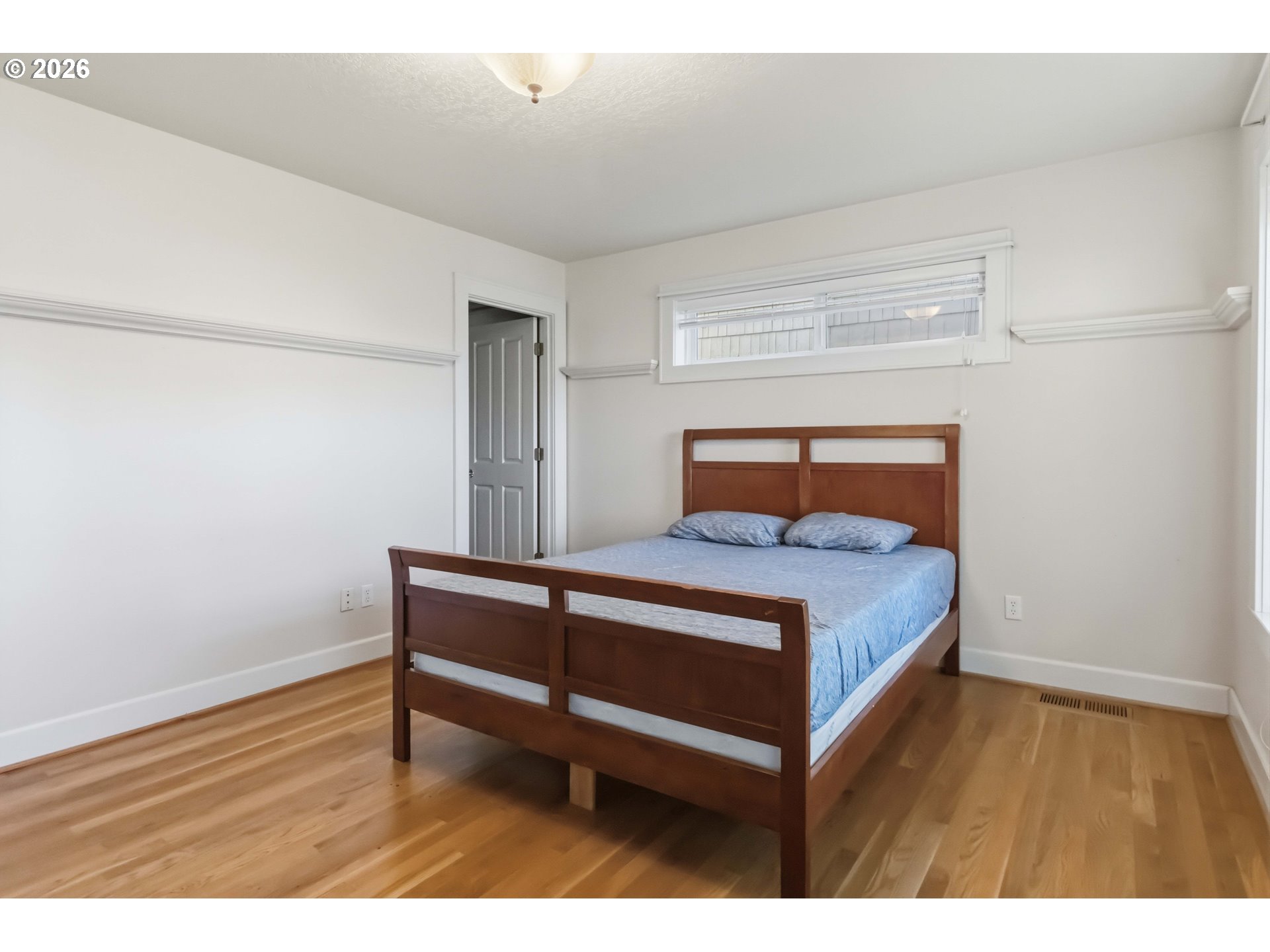 3008 Garfield Street Longview, WA 98632 - Photo 25 of 45 a bedroom with a bed and wooden floor