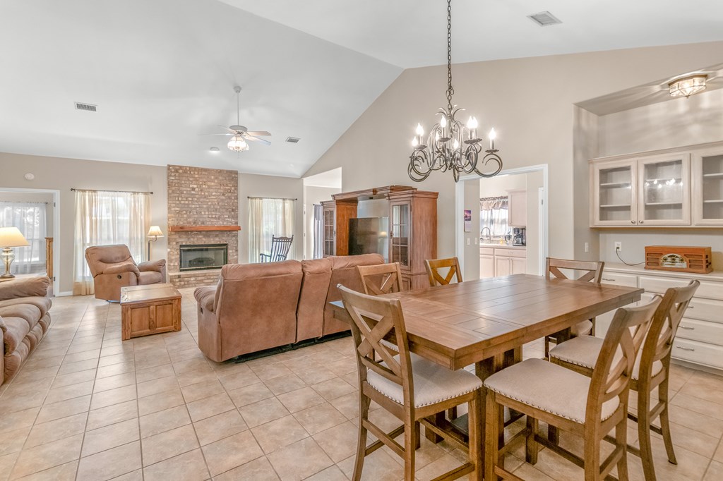 225 Los Cedros Loop Kerrville, TX 78028 - Photo 14 of 27 a dining room filled chandelier and kitchen view