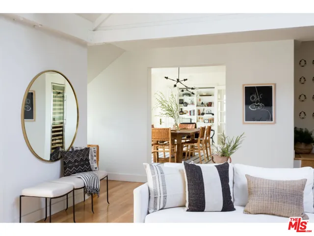 a living room with furniture a rug and a large window