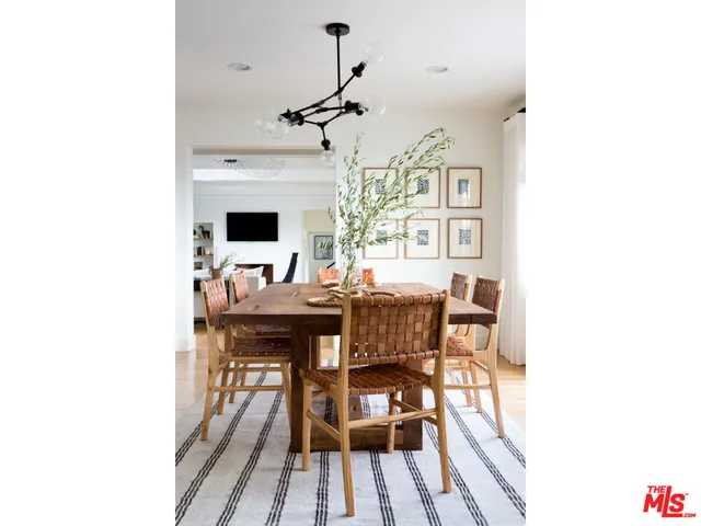 a view of a dining room with furniture and a chandelier