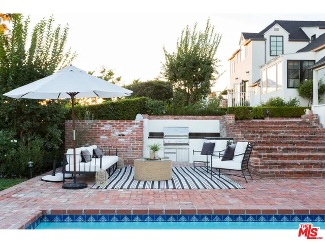 a view of a house with backyard porch and sitting area