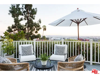 a view of a patio with couches chairs and a potted plant