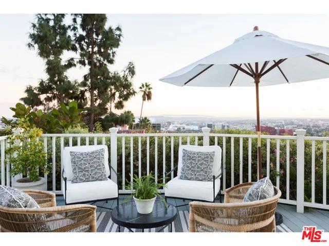 a view of a patio with couches chairs and a potted plant