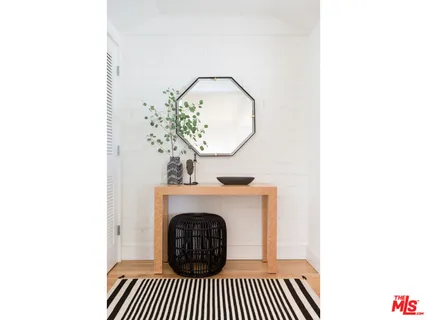 a living room with a fireplace and a potted plant
