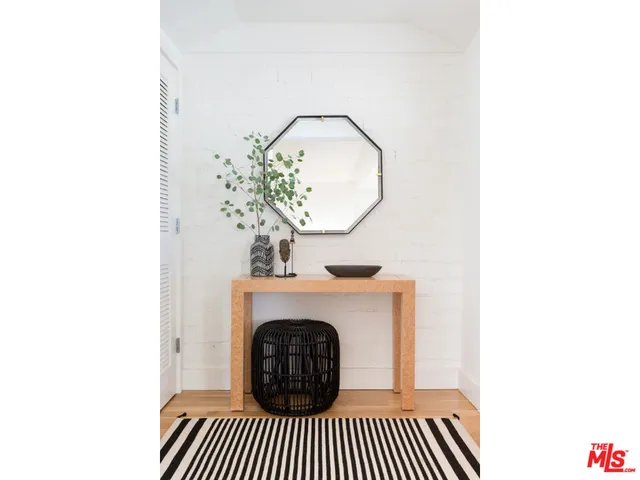 a living room with a fireplace and a potted plant