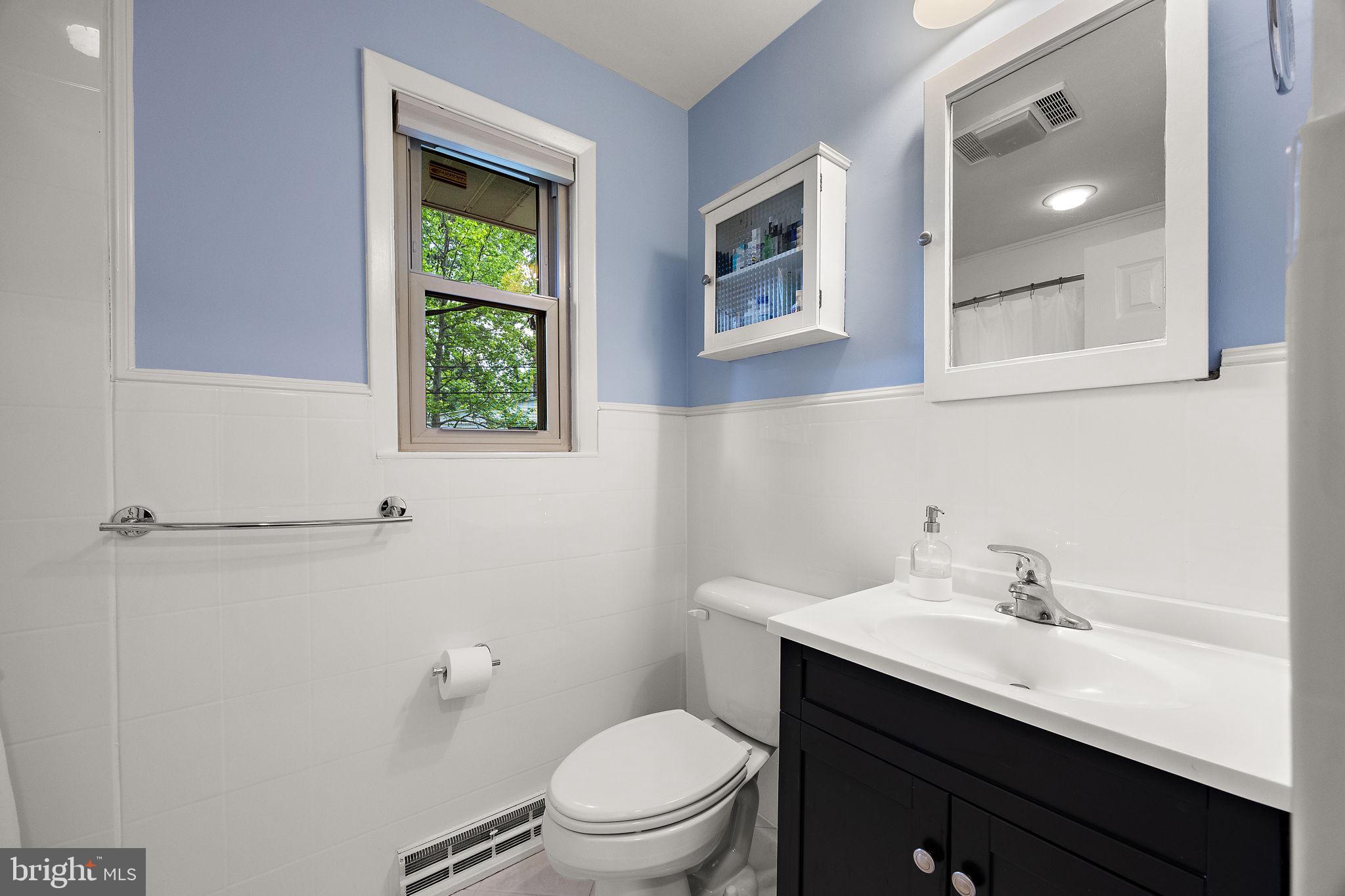 601 Riverview Road Claymont, DE 19703 - Photo 24 of 33 a bathroom with a sink a toilet a window and mirror