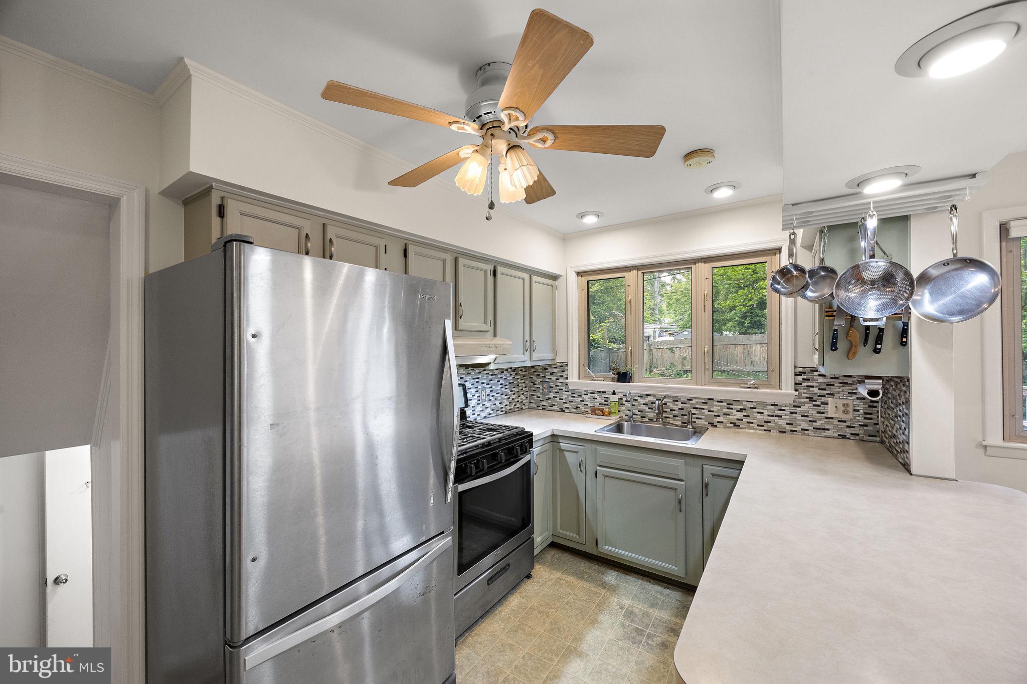 601 Riverview Road Claymont, DE 19703 - Photo 9 of 33 a kitchen with stainless steel appliances a stove a refrigerator and a sink