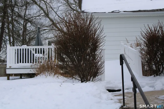 a view of deck in front of house with trees