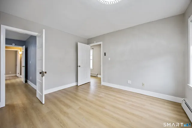 a view of an empty room and wooden floor